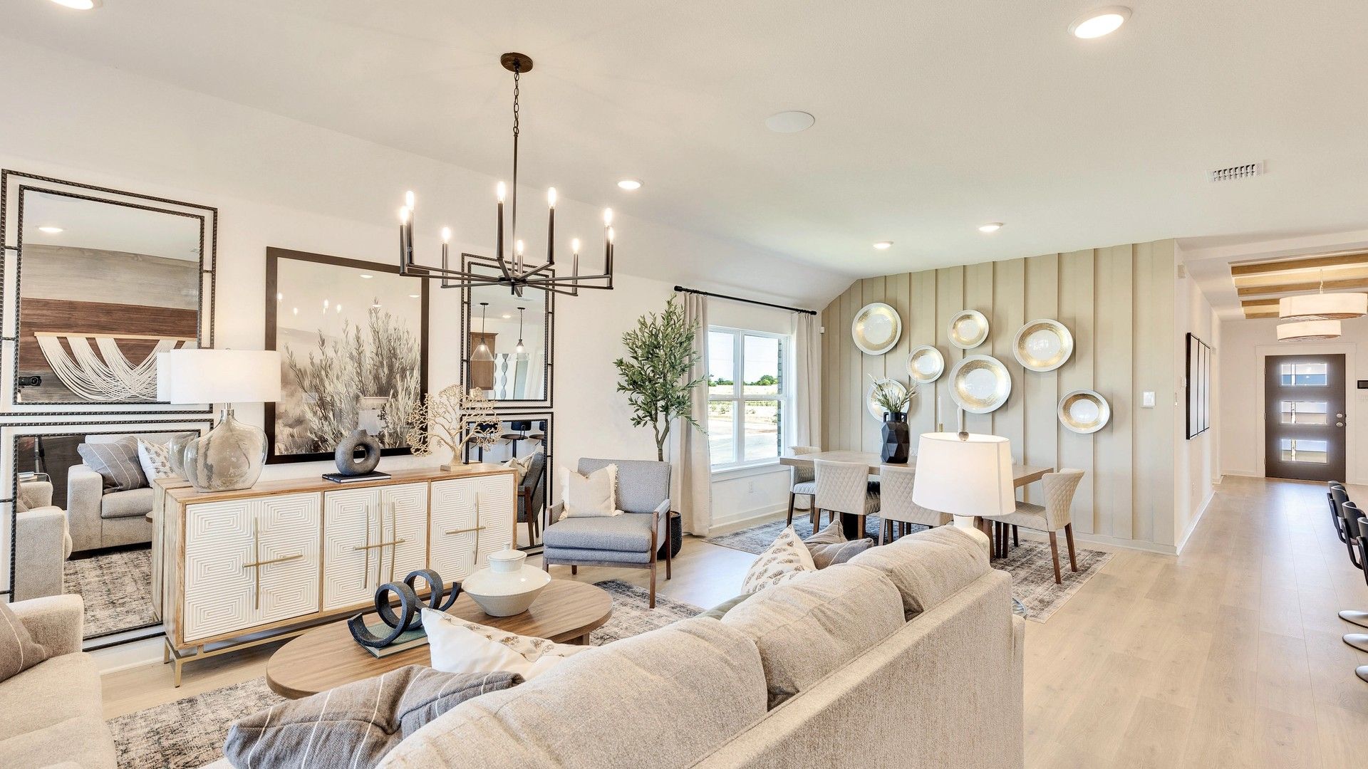Hunter’s Glen living room boasts a chic chandelier, wood accents, and designer wall art.