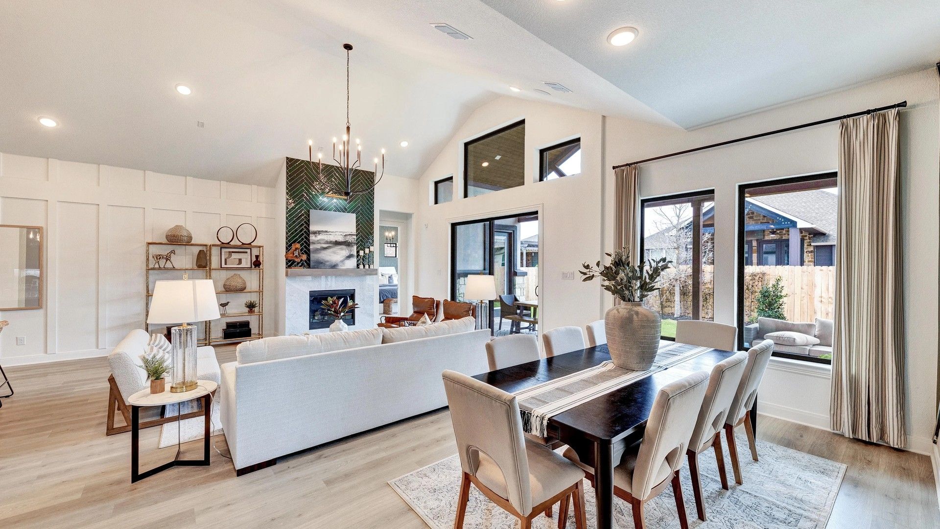 Luxurious vaulted ceiling, sleek fireplace, expansive windows in Hawkes Landing. Exquisite design elegance.