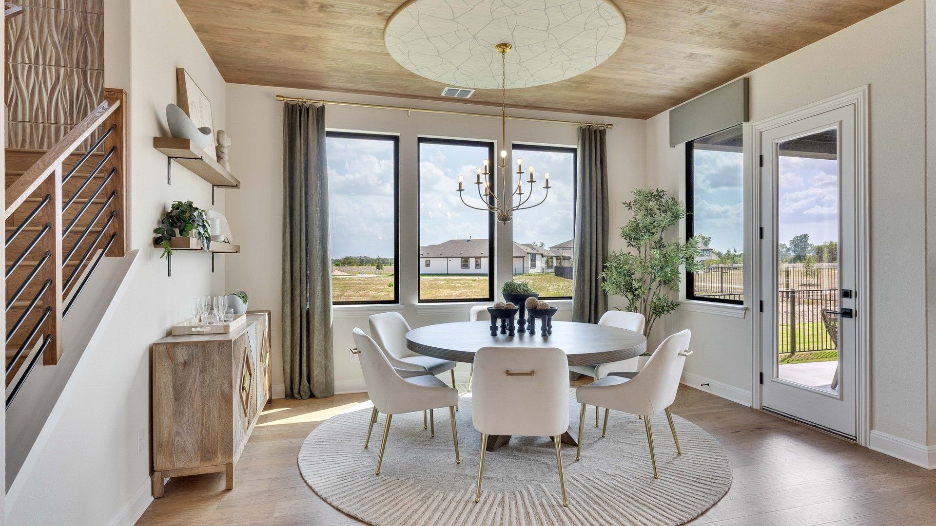 Experience sophistication with wood ceiling, grand windows, and chic decor at Lakeside Meadows' Preserve.