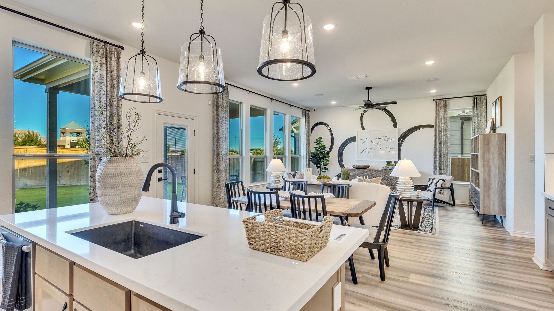 Open-concept space boasts quartz countertops, designer lighting, and expansive windows in Briarwood community.