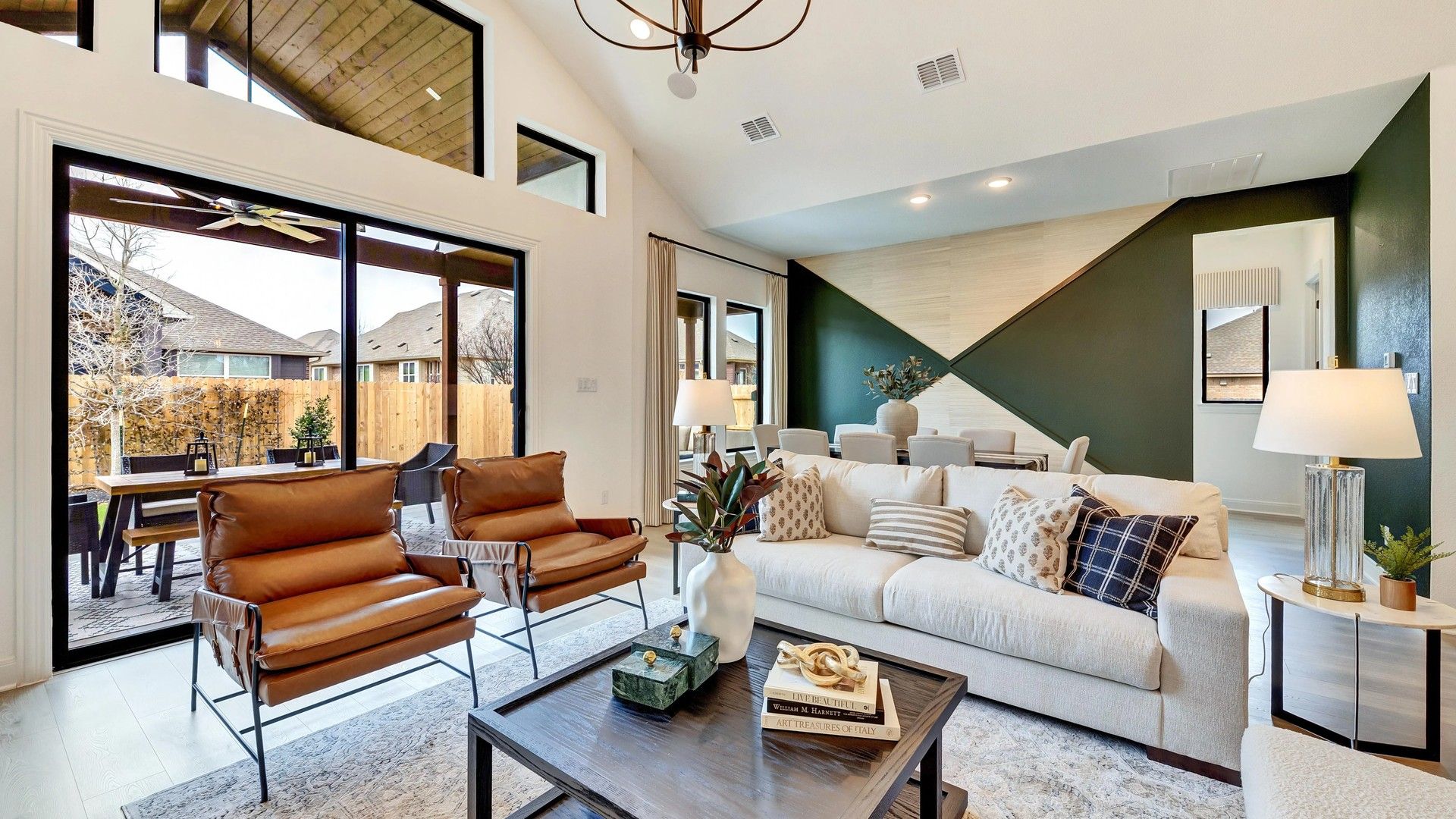 Open-concept living with designer chandelier, lofty ceilings, and chic accents in Hawkes Landing.