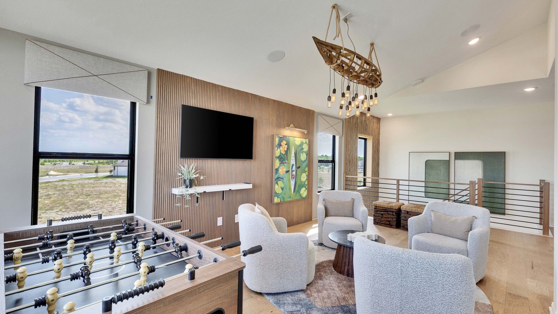 Elegant game room with bespoke chandelier, textured walls, and plush seating in Preserve at Lakeside Meadows.