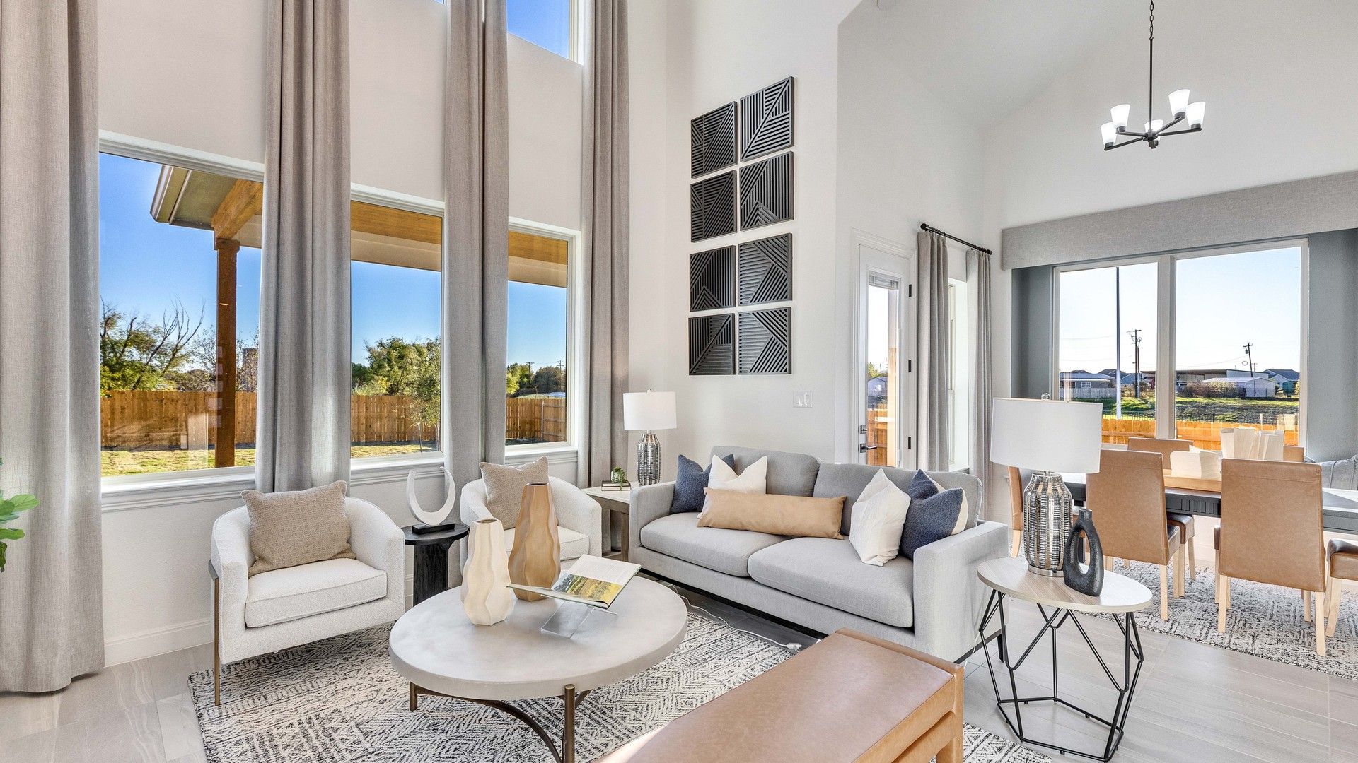 Luxe high ceilings and expansive windows define this exquisite Creeks Crossing living space.