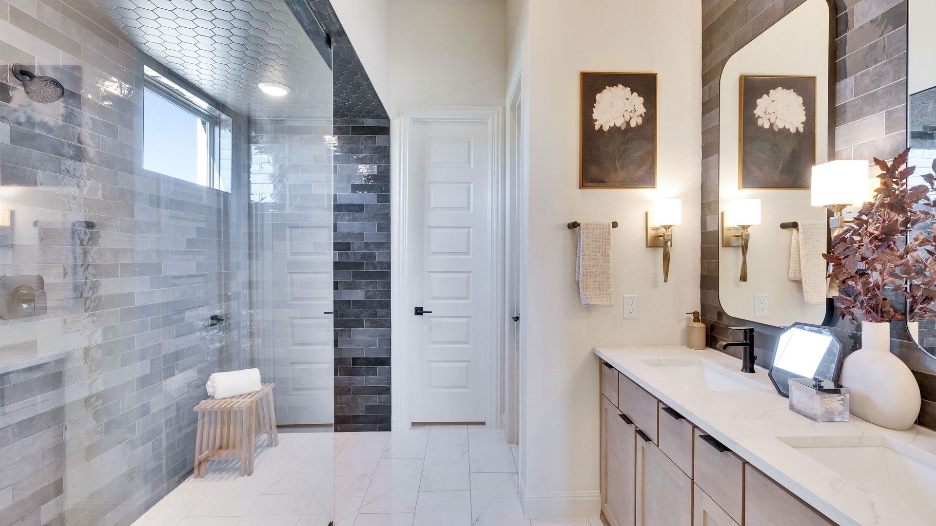 Experience sophistication in Flora with marble surfaces, seamless glass shower, and stylish tilework enhancing luxury living.