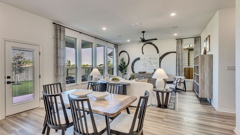 Elegant open-concept living area with expansive windows and premium light wood flooring in Briarwood.