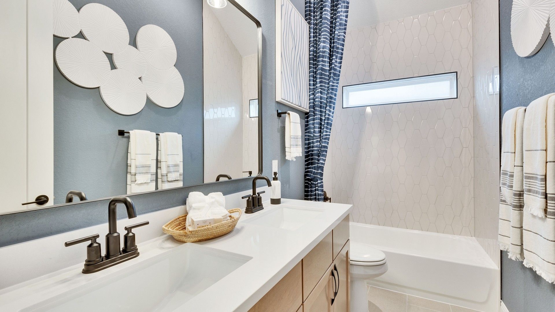 Elegantly designed bathroom with hexagonal tiles and sophisticated double vanity in Spring Creek.