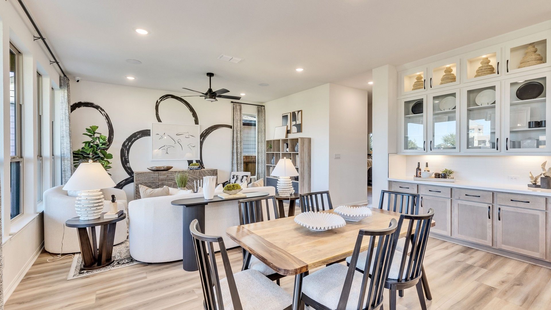 Exquisite dining area with sleek cabinetry and light wood flooring in Briarwood. Distinctive architectural artistry.
