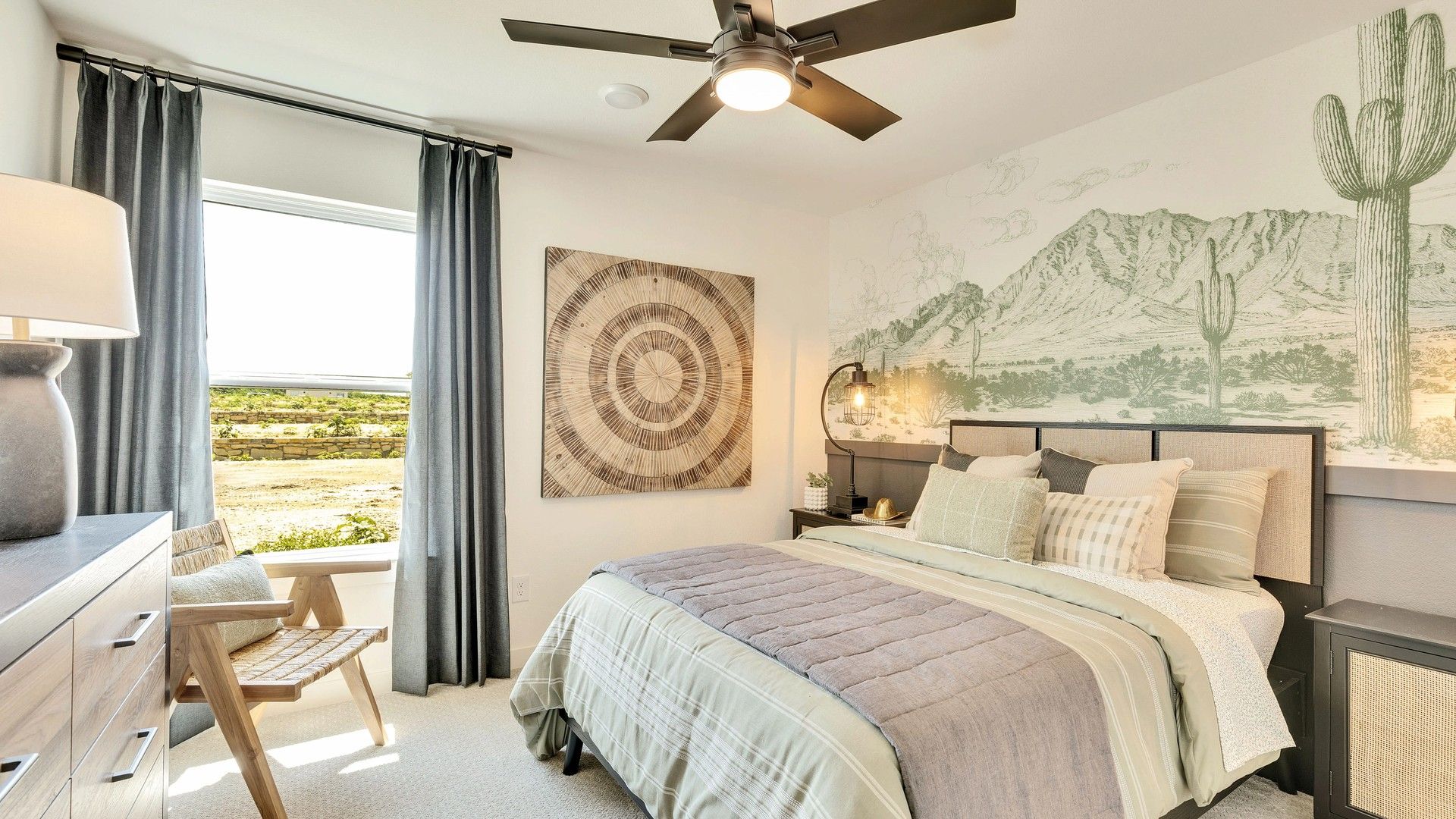 Discover elegance in this Hunters Glen bedroom, featuring a stunning mountain mural and sleek fan.