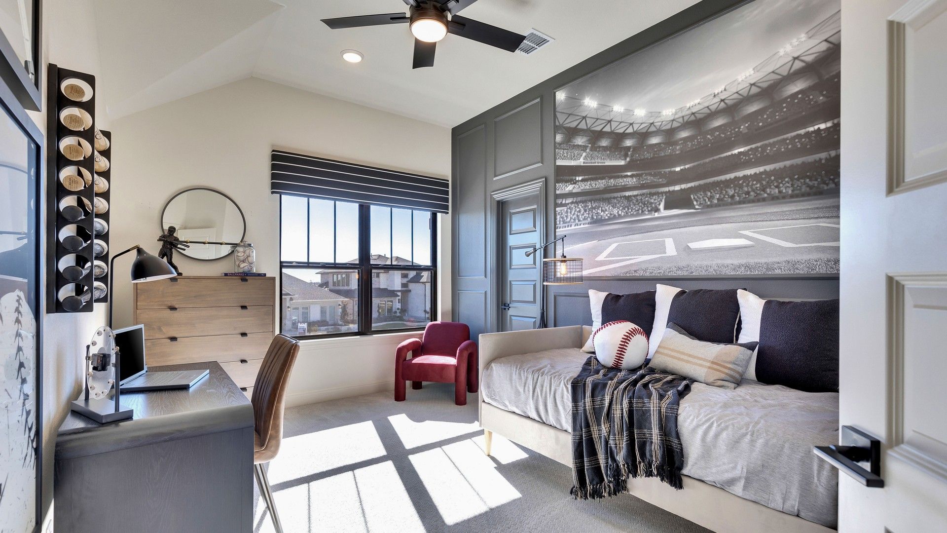Elegant bedroom features a striking baseball mural, plush daybed, and chic decor in Flora community.