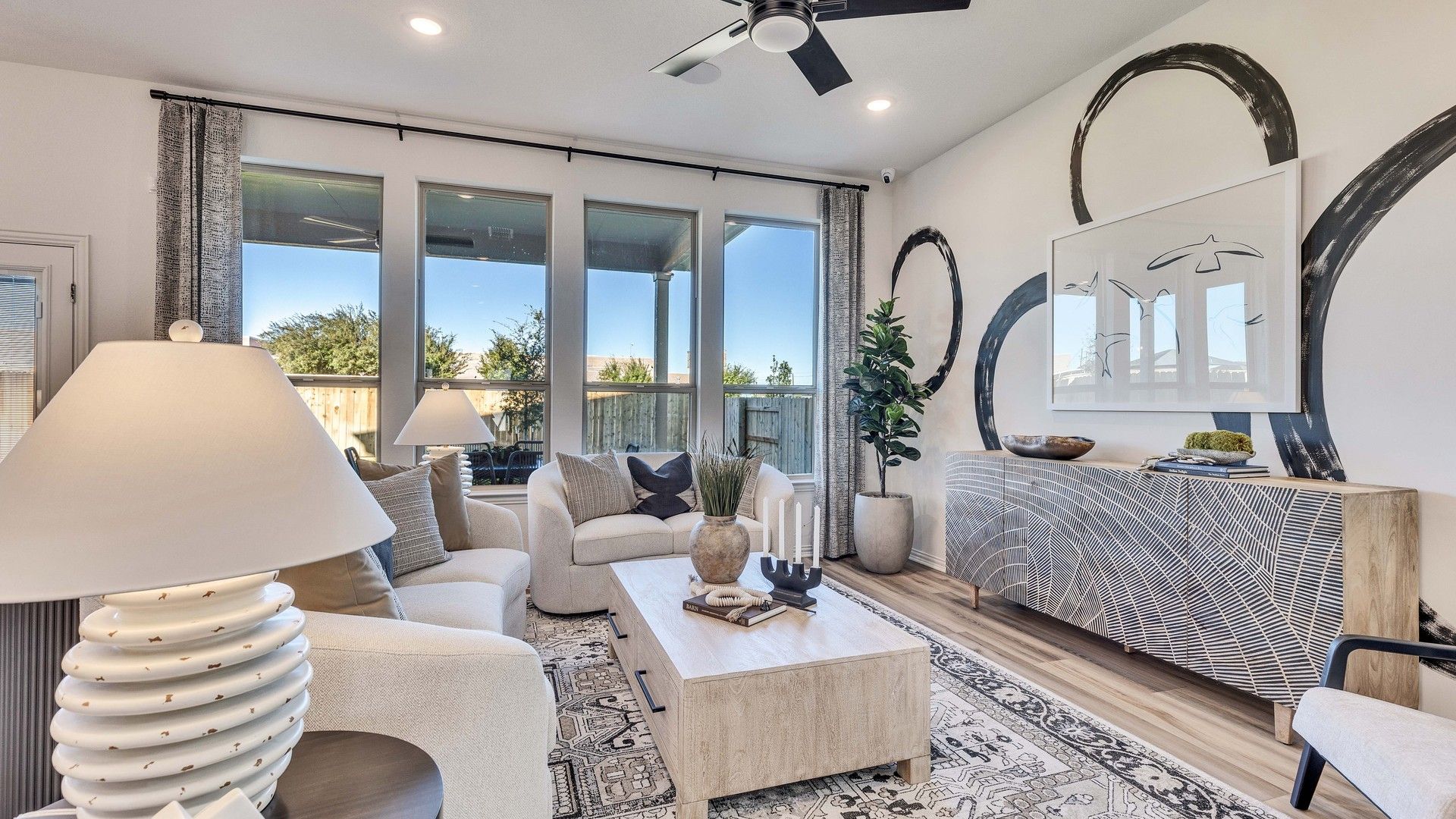 Elegant Briarwood living area with artful wall decor, expansive windows, and exquisite modern furnishings.