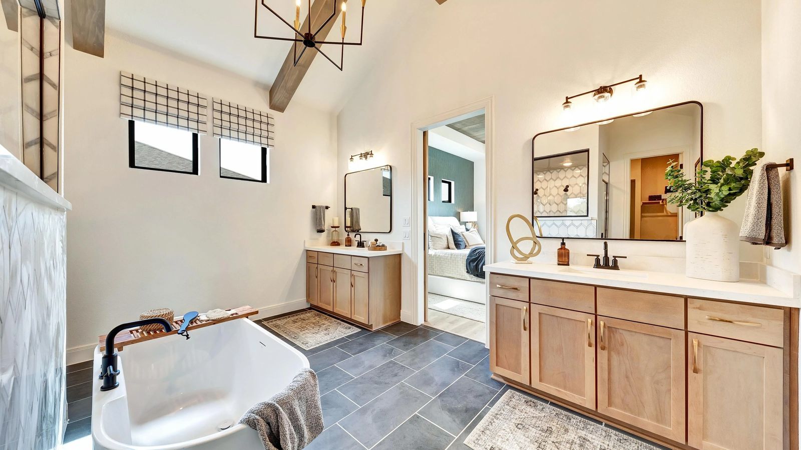 Enjoy elegance with a freestanding tub, wood vanity, and chic tile floor in Hawkes Landing.