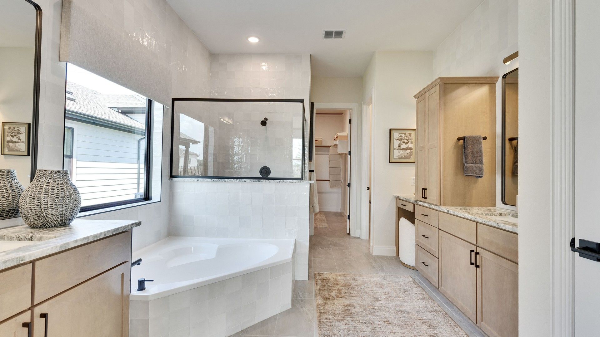 Exquisite Lakeside Meadows bathroom with alcove tub, expansive marble counters, and bespoke cabinetry.