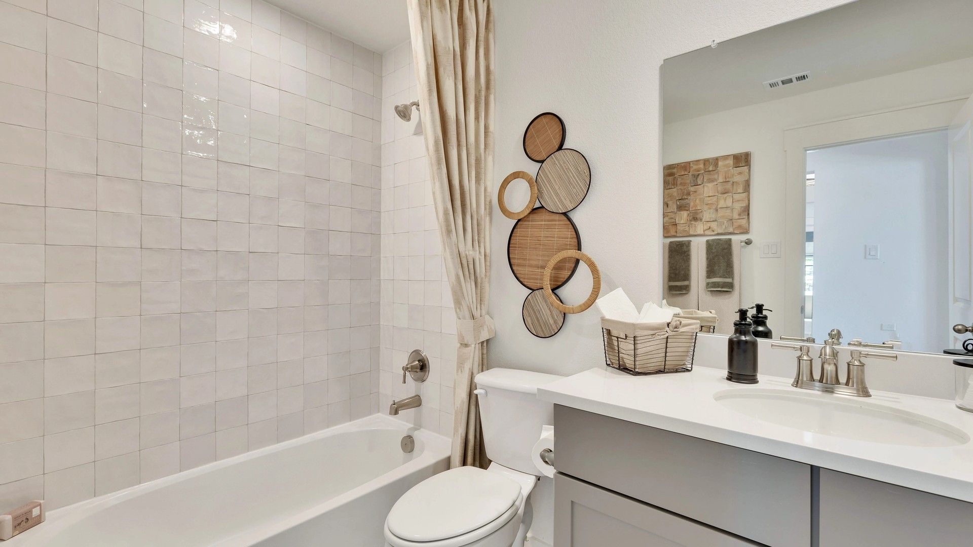 Elegant tiles and modern fixtures enhance this exquisite bathroom in Hunters Glen community.