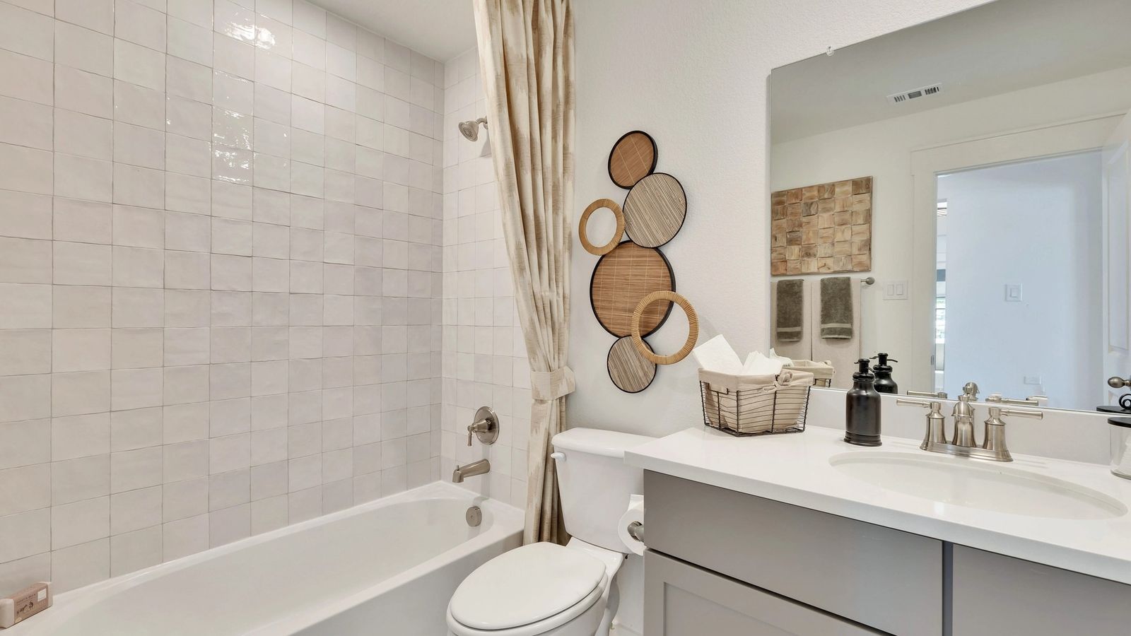 Elegant tiles and modern fixtures enhance this exquisite bathroom in Hunters Glen community.