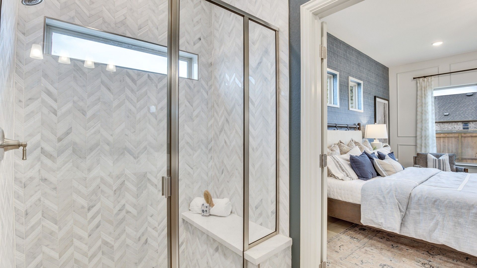 Opal Ranch offers a sophisticated bathroom with chevron marble tile and seamless bedroom entry.