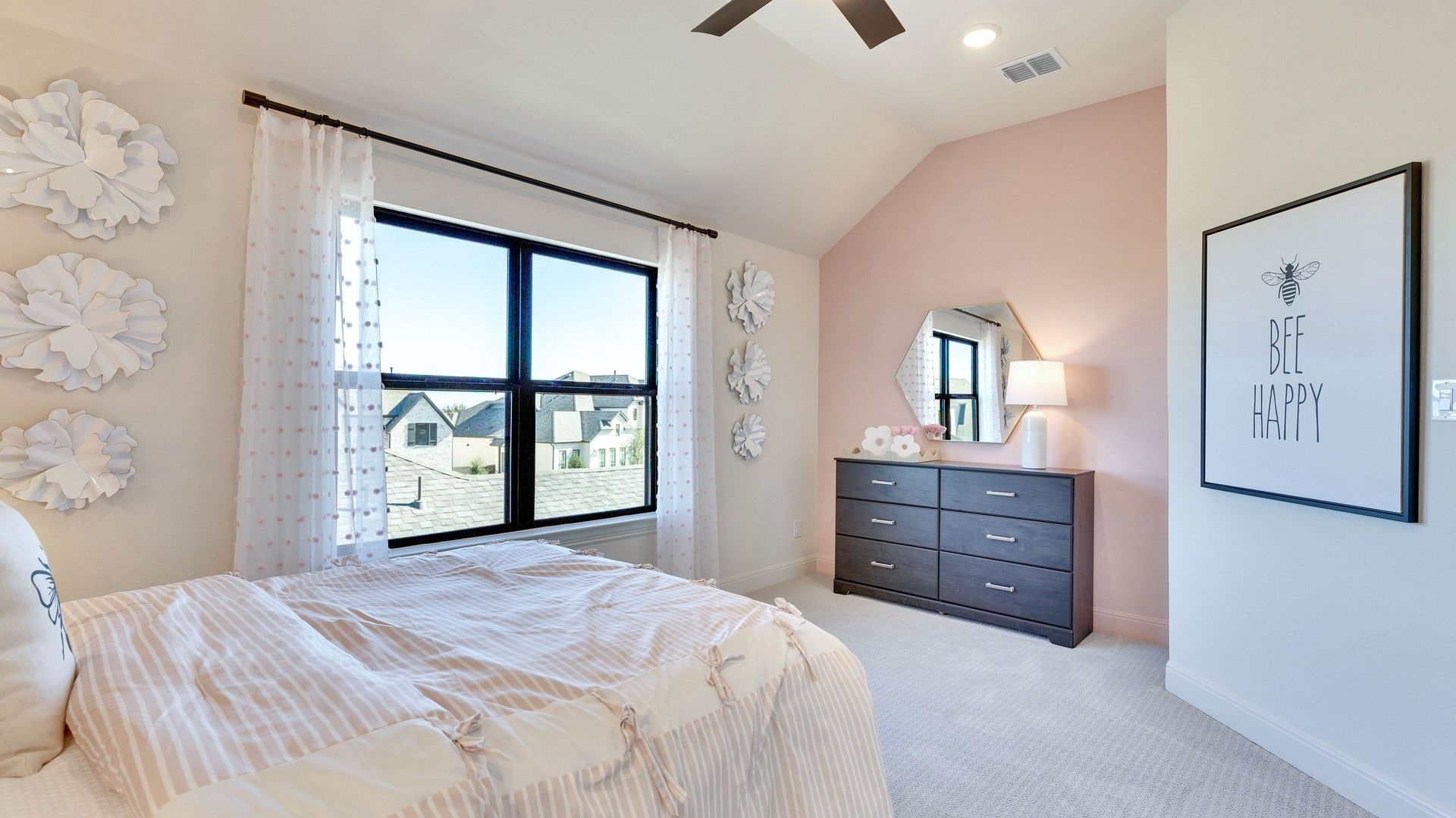 Discover the charm of a soft pink accent wall and high-end furnishings in Flora Community.