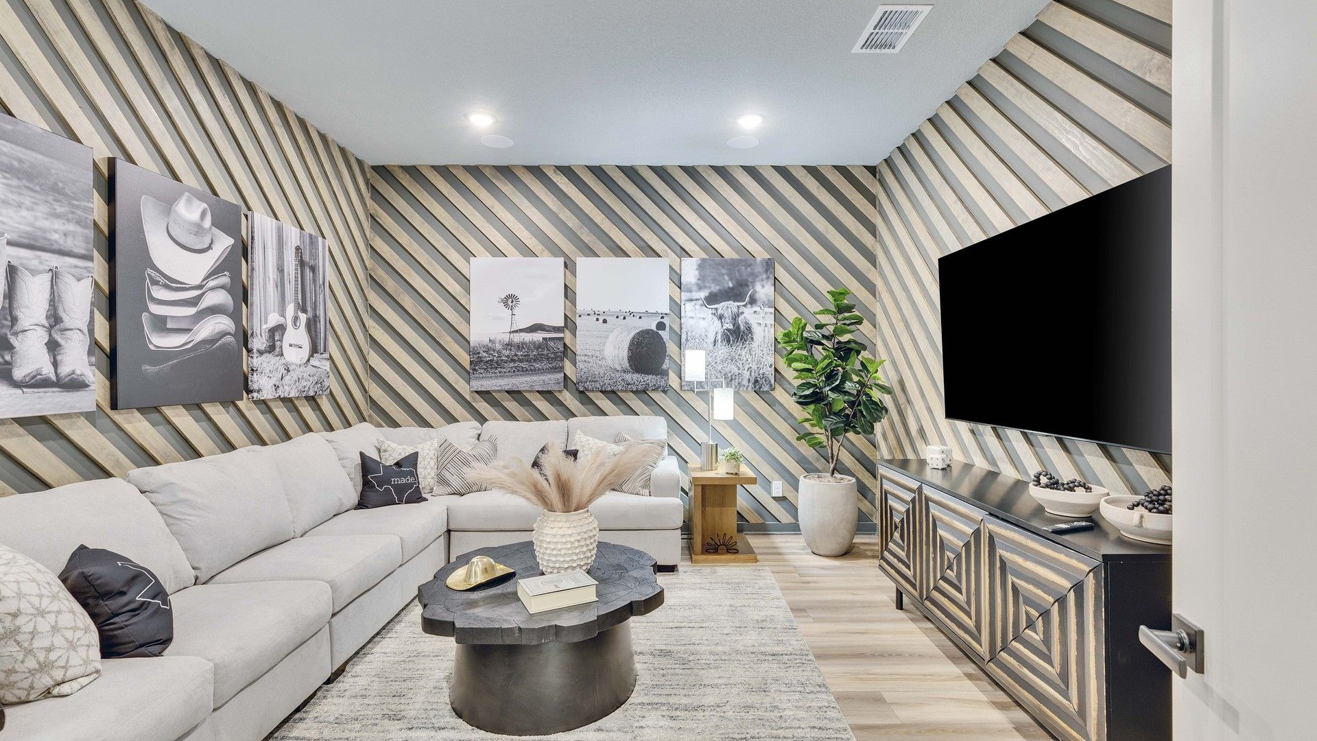 Briarwood’s living space wows with striking diagonal wood panels and high-end decor, blending modernity with comfort.