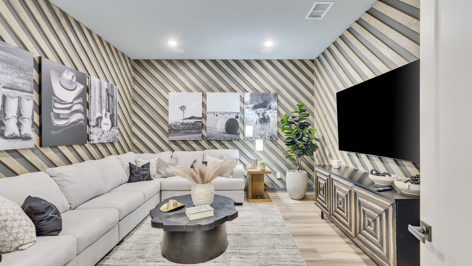 Briarwood’s living space wows with striking diagonal wood panels and high-end decor, blending modernity with comfort.