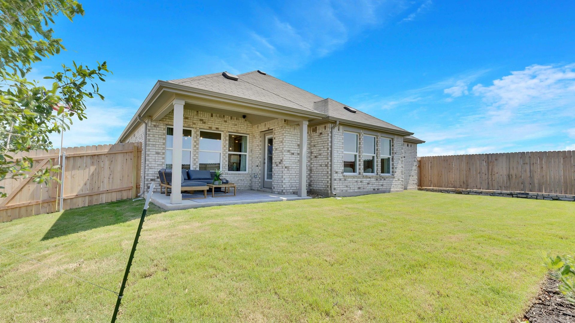 Luxurious brick facade and expansive patio enhance Hunts Glen's serene courtyard ambiance.