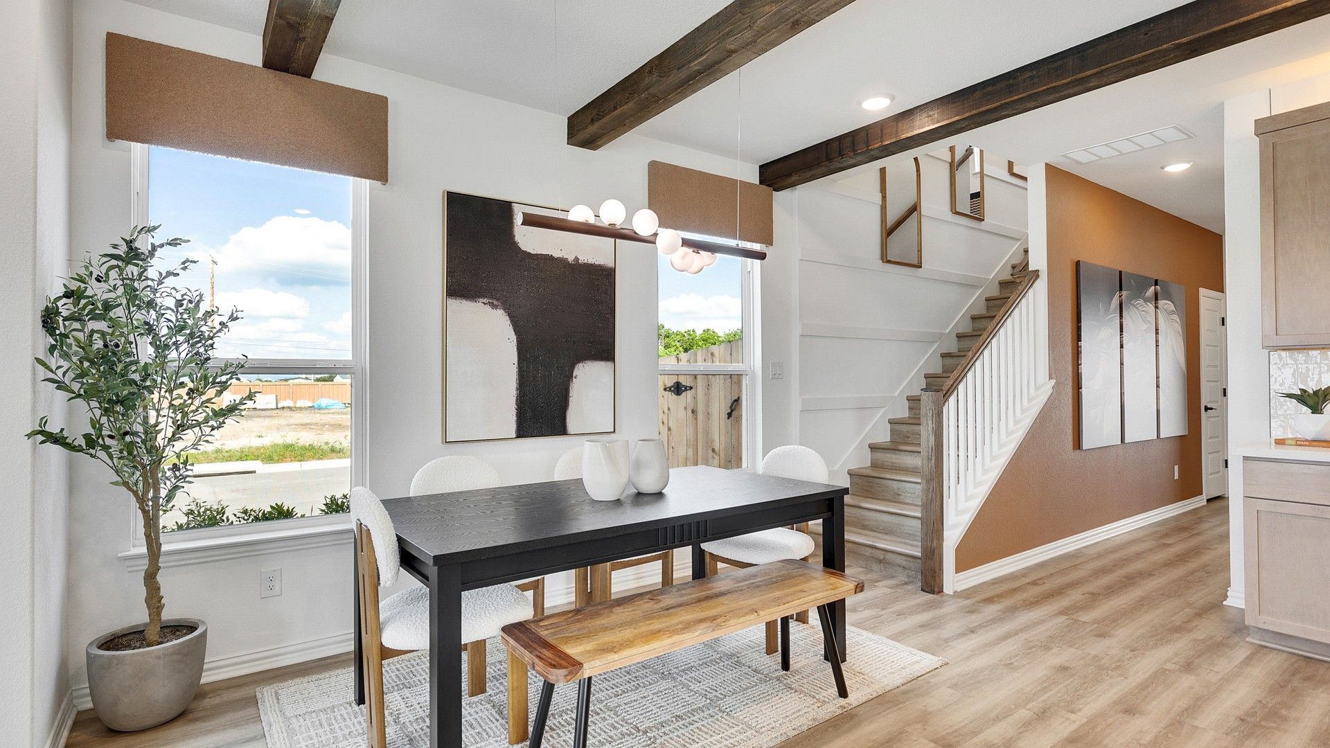 Experience elegance with exposed beams, rich wood flooring, and art accents in Spring Creek.