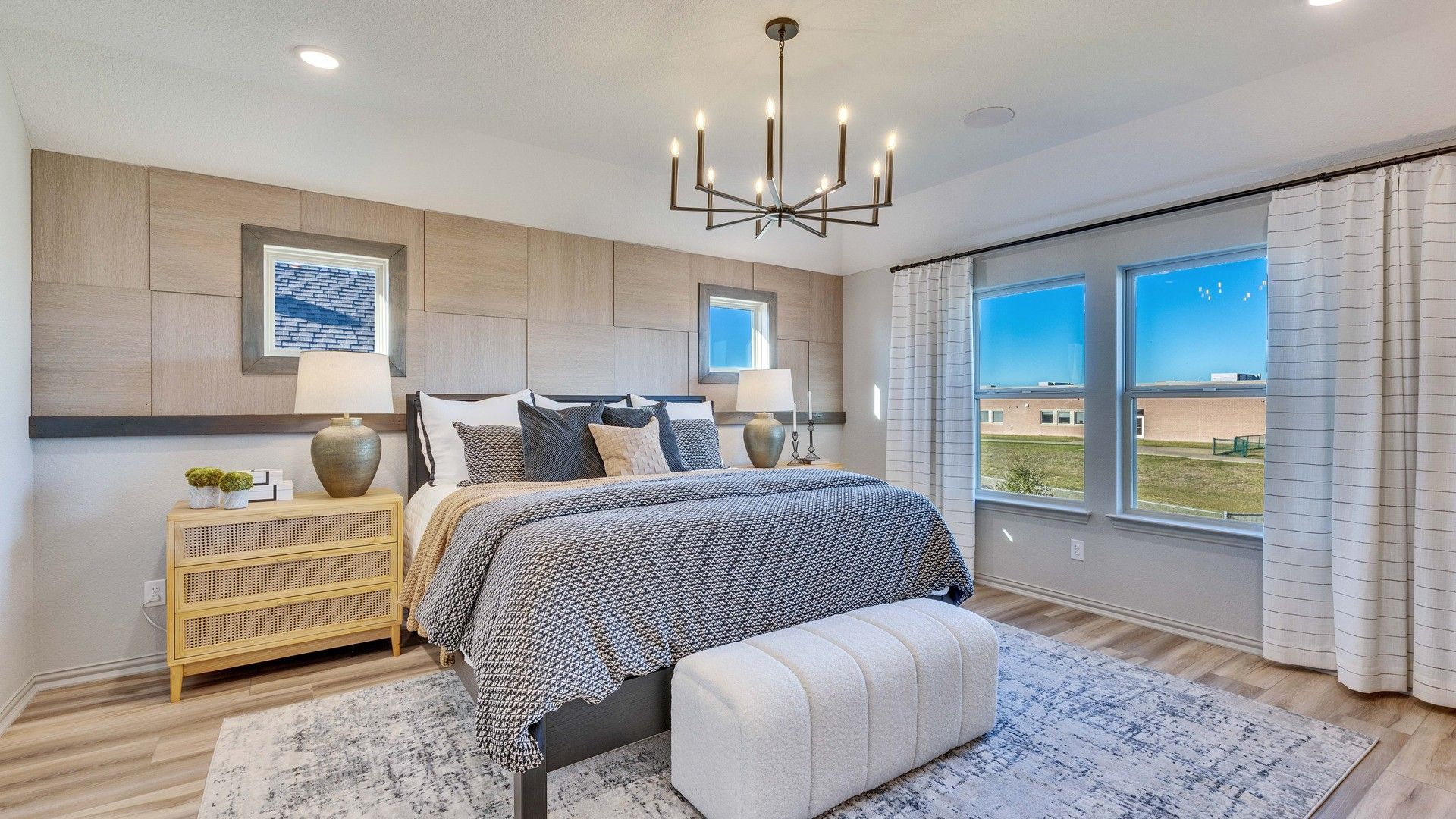 Briarwood bedroom features exquisite wood paneling, plush textures, and a stunning chandelier.