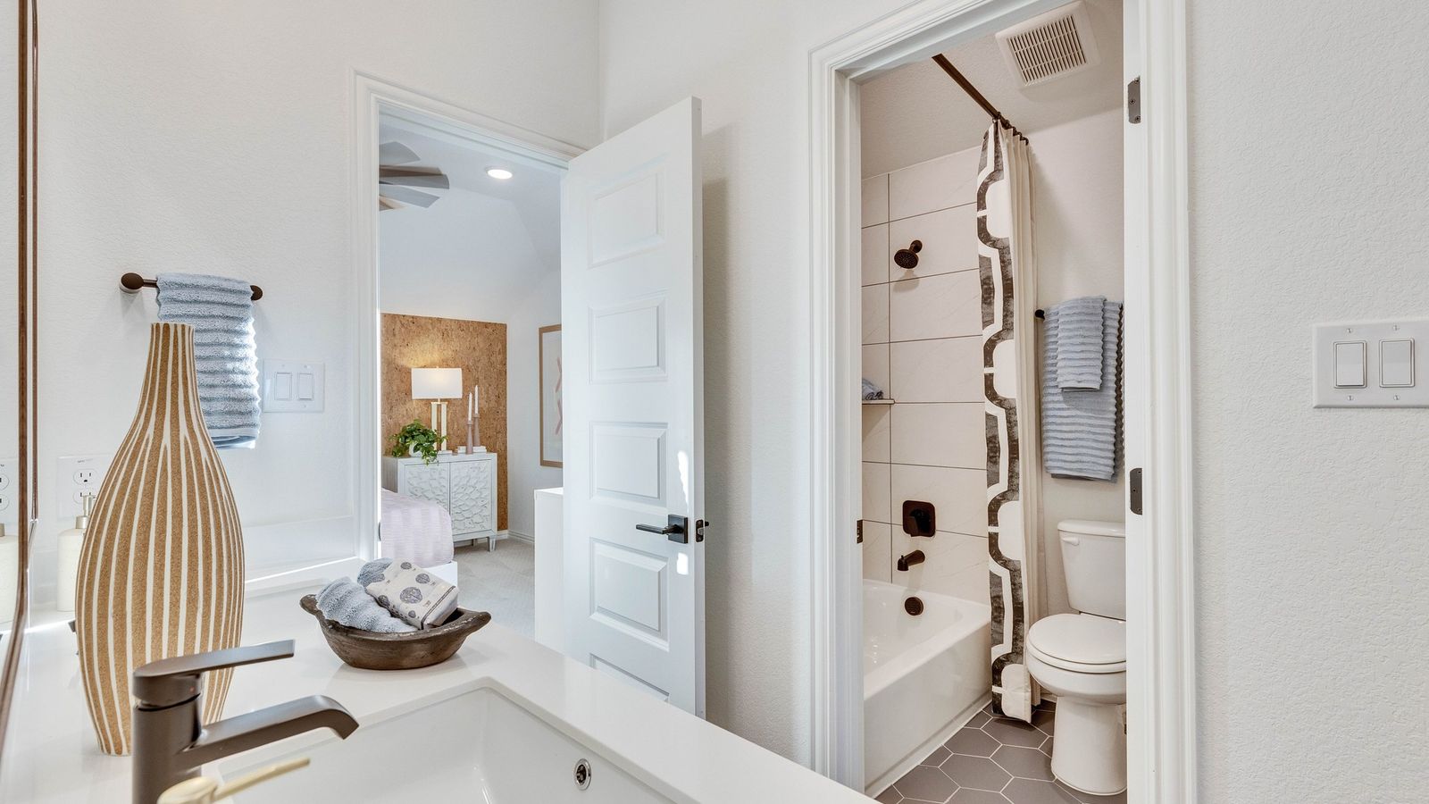 Exquisite hexagonal tile and sleek fixtures in Creeks Crossing enhance modern luxury.