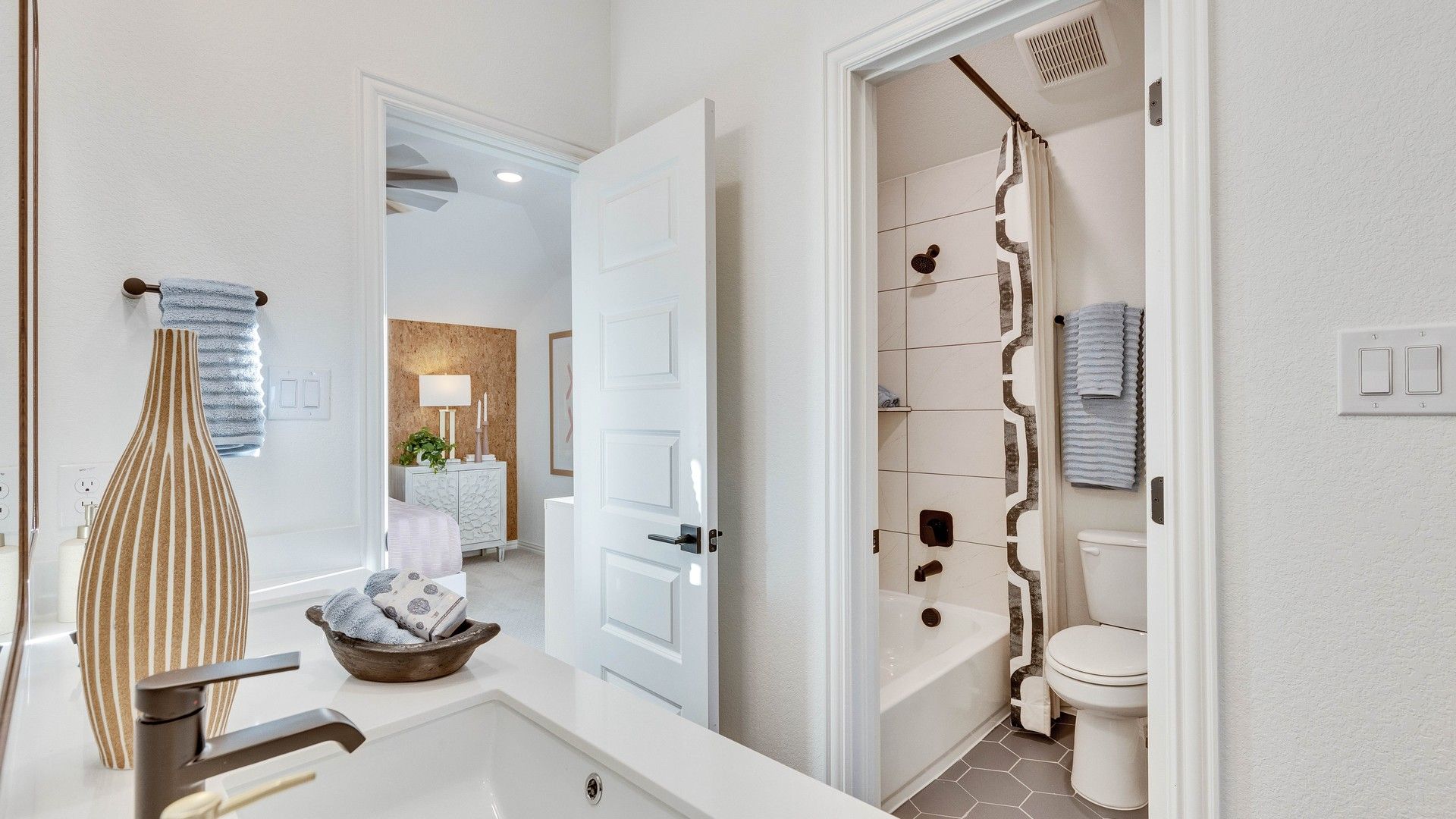 Exquisite hexagonal tile and sleek fixtures in Creeks Crossing enhance modern luxury.