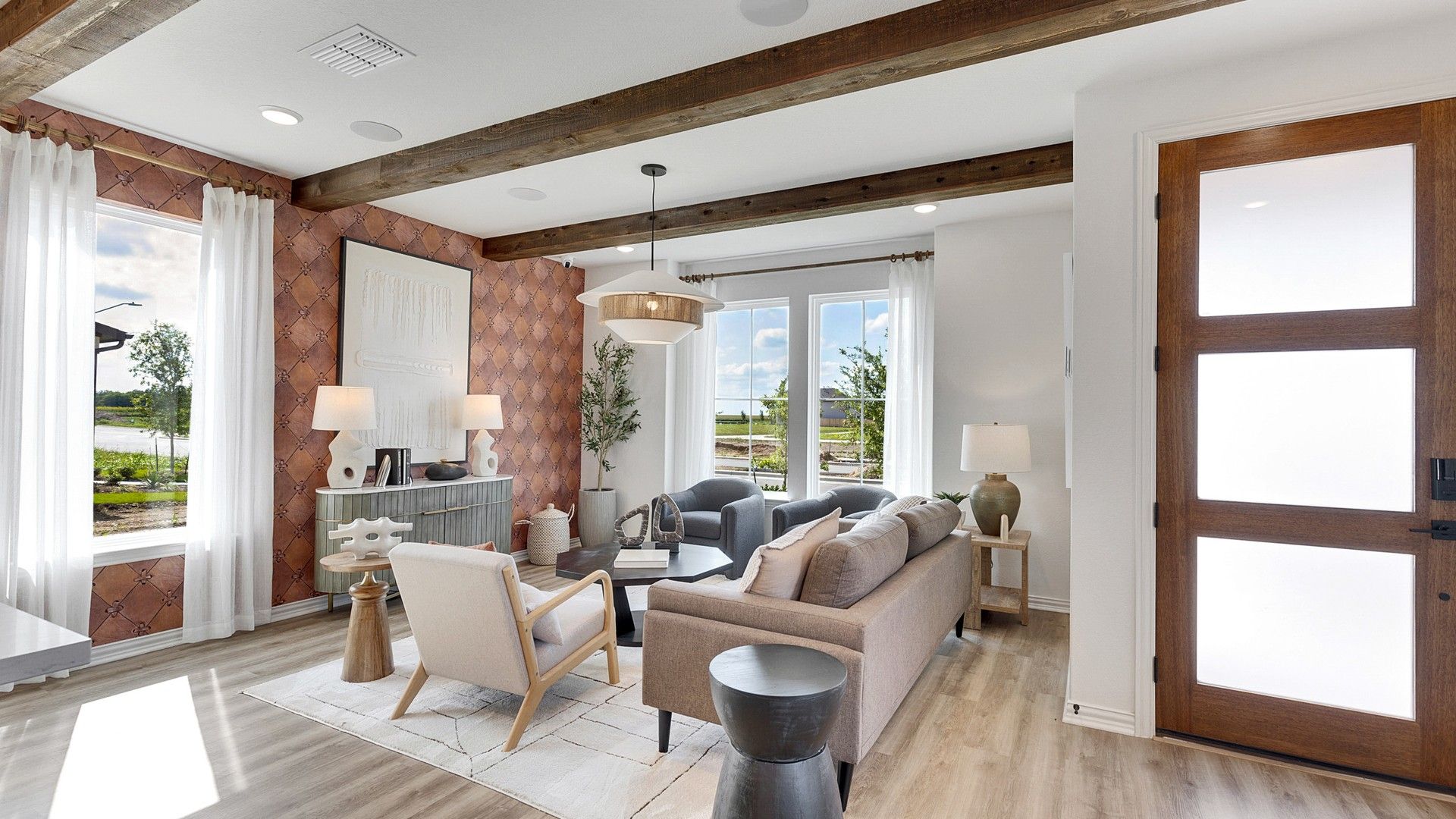 Luxurious design features rustic beams, expansive windows, plush furnishings in Spring Creek.