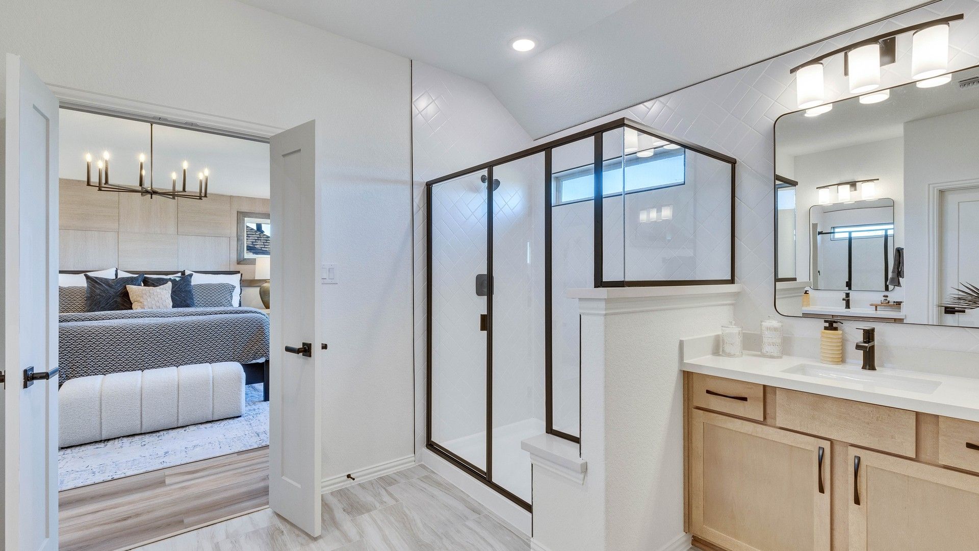 This Briarwood bathroom boasts a sleek glass shower and custom wood cabinetry, epitomizing elegant craftsmanship.