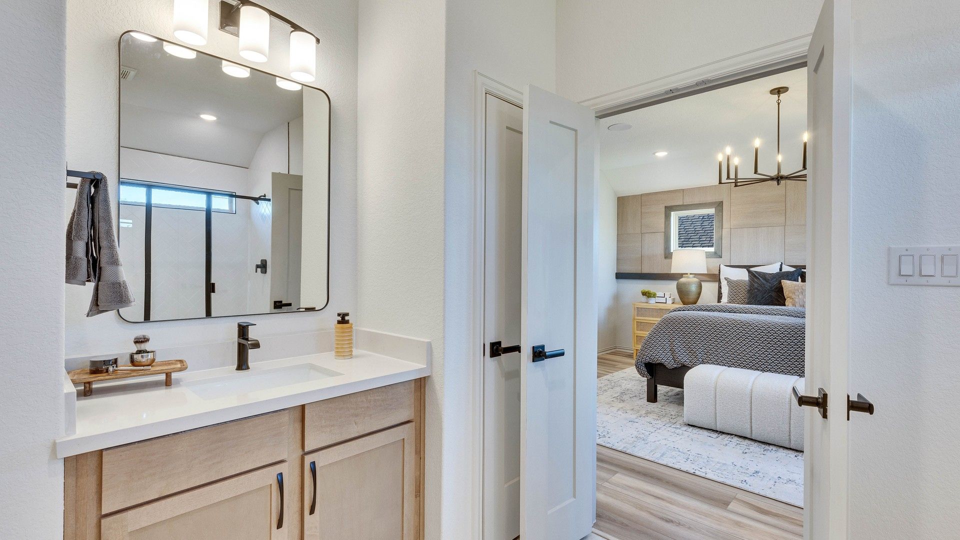 Elegant bathroom with chic fixtures transitions to a refined bedroom suite in Briarwood.