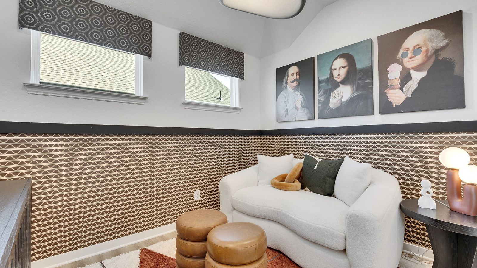 Geometric wallpaper and plush seating create a sophisticated aesthetic in this Spring Creek space.