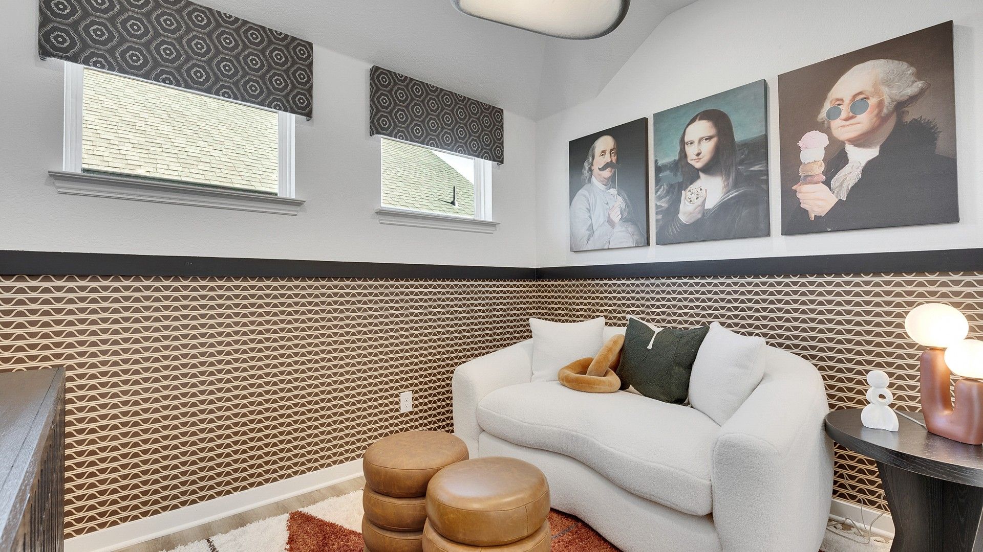 Geometric wallpaper and plush seating create a sophisticated aesthetic in this Spring Creek space.