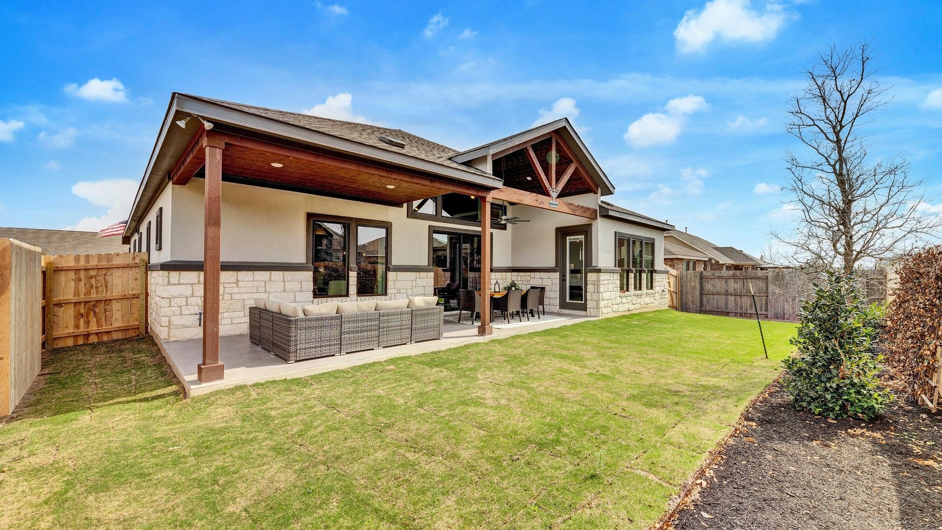 Luxurious stone facade and expansive covered patio in exclusive Hawkes Landing, Texas.