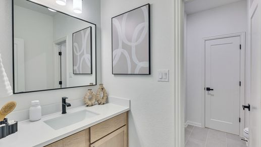 Sleek wood cabinetry and elegant contemporary fixtures enhance this Briarwood bathroom.