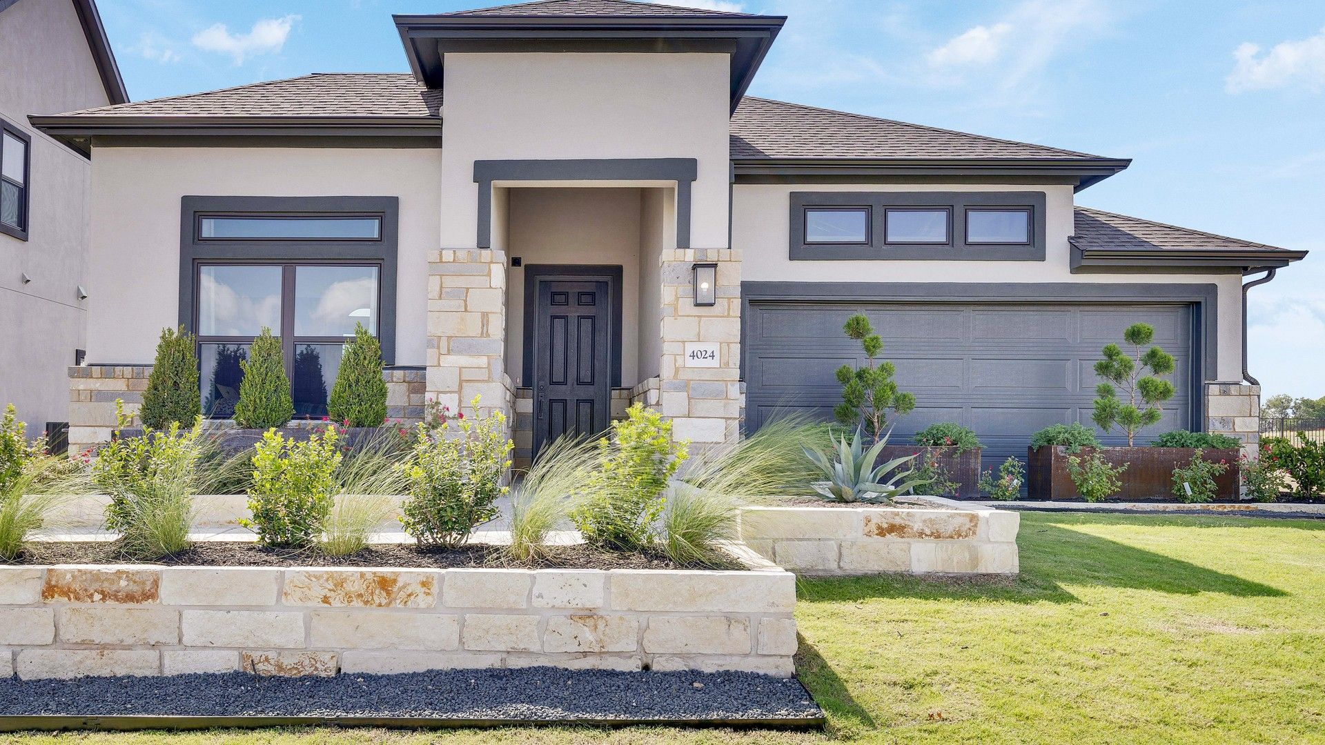 Elegant stone accents, expansive windows, and pristine landscaping define this Lakeside Meadows gem.