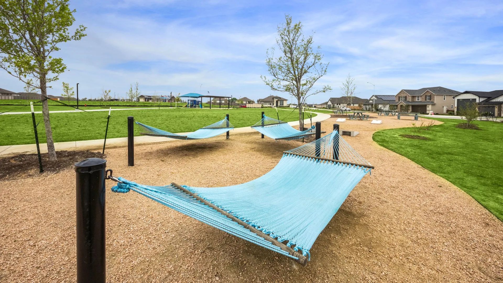 Embrace tranquility with elegant hammocks amidst lush greenery in Carillon community's upscale park.