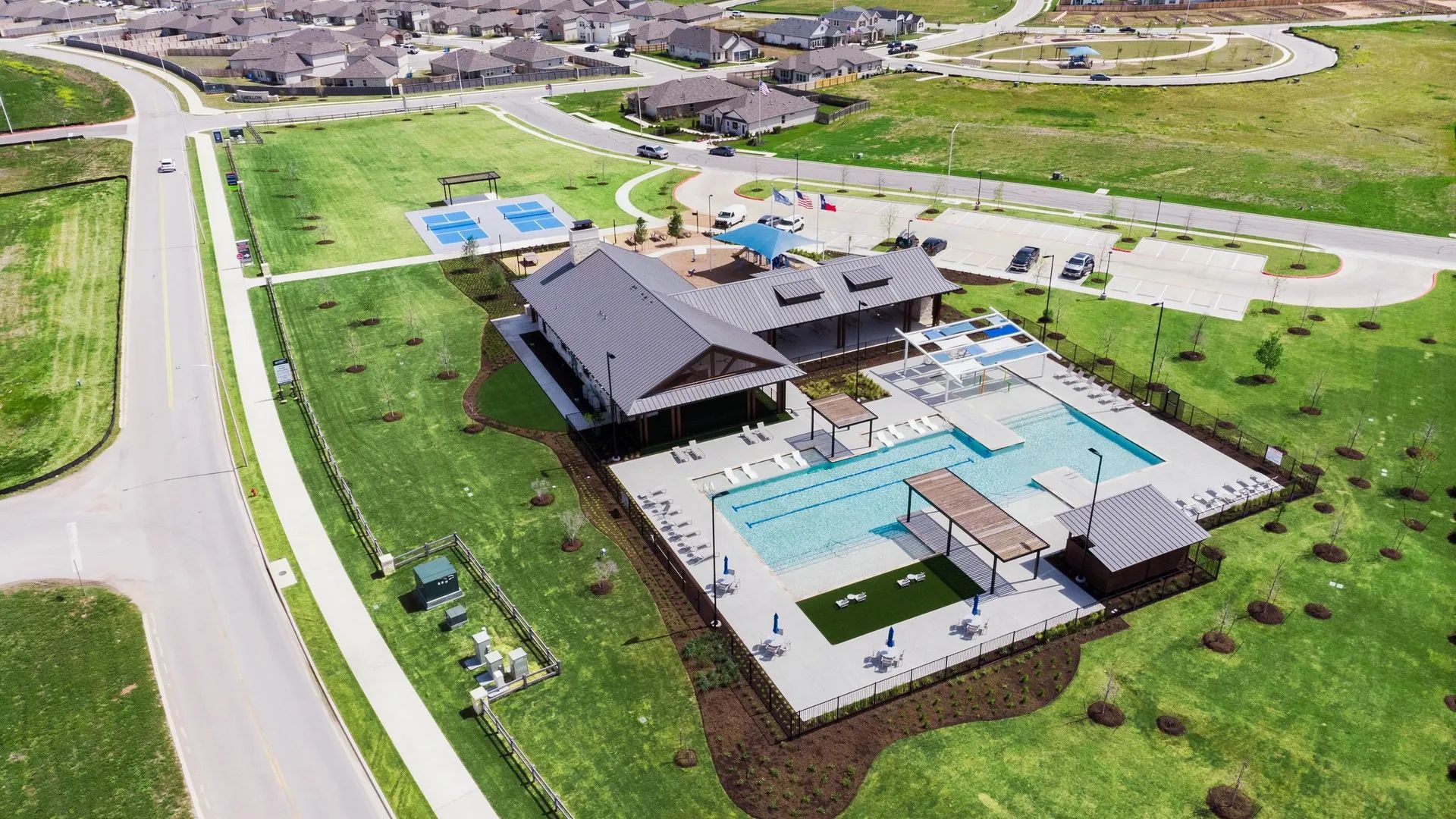 Carillon's luxury clubhouse features a modern pool, chic pavilions, and exquisite landscaping amidst serene surroundings.