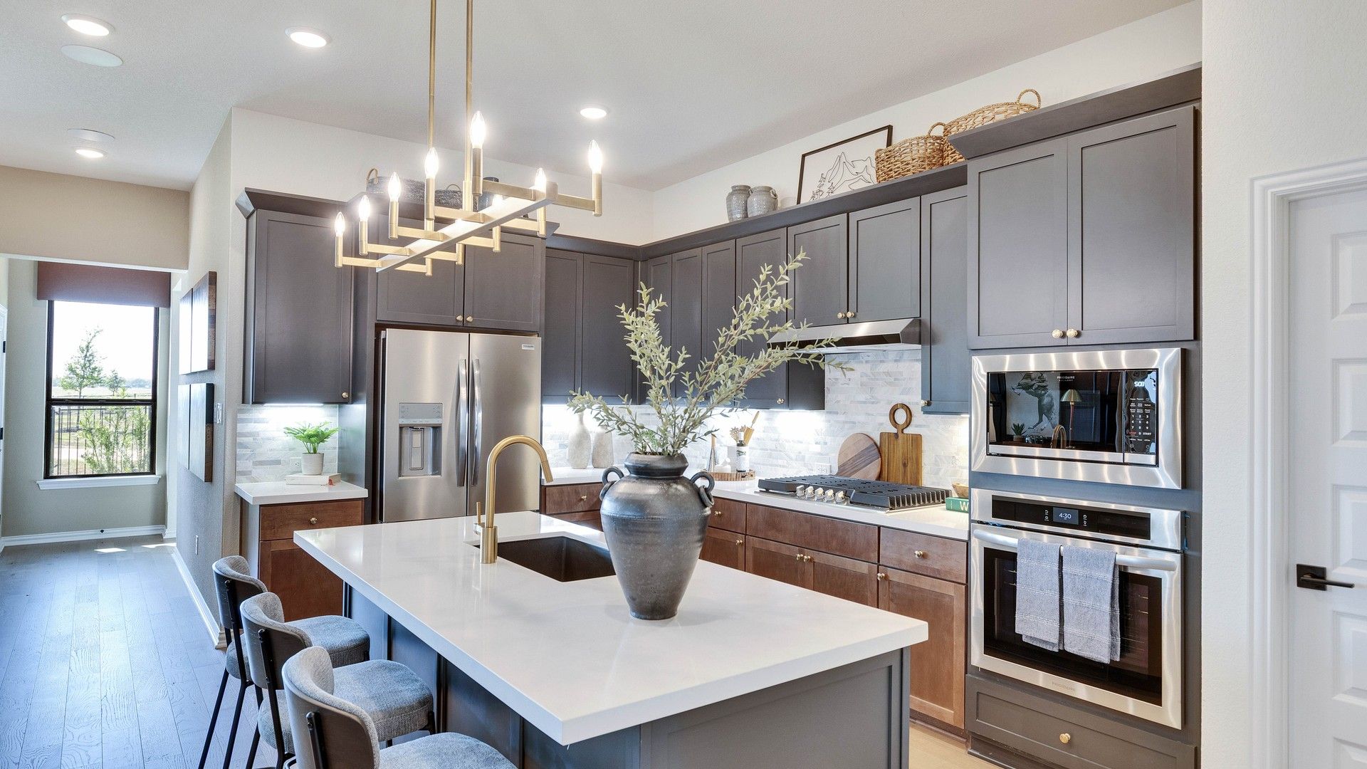Elegant cabinetry and sleek island elevate this Lakeside Meadows kitchen's sophisticated charm.