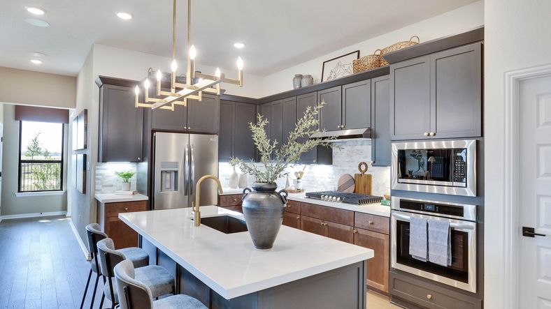 Elegant cabinetry and sleek island elevate this Lakeside Meadows kitchen's sophisticated charm.
