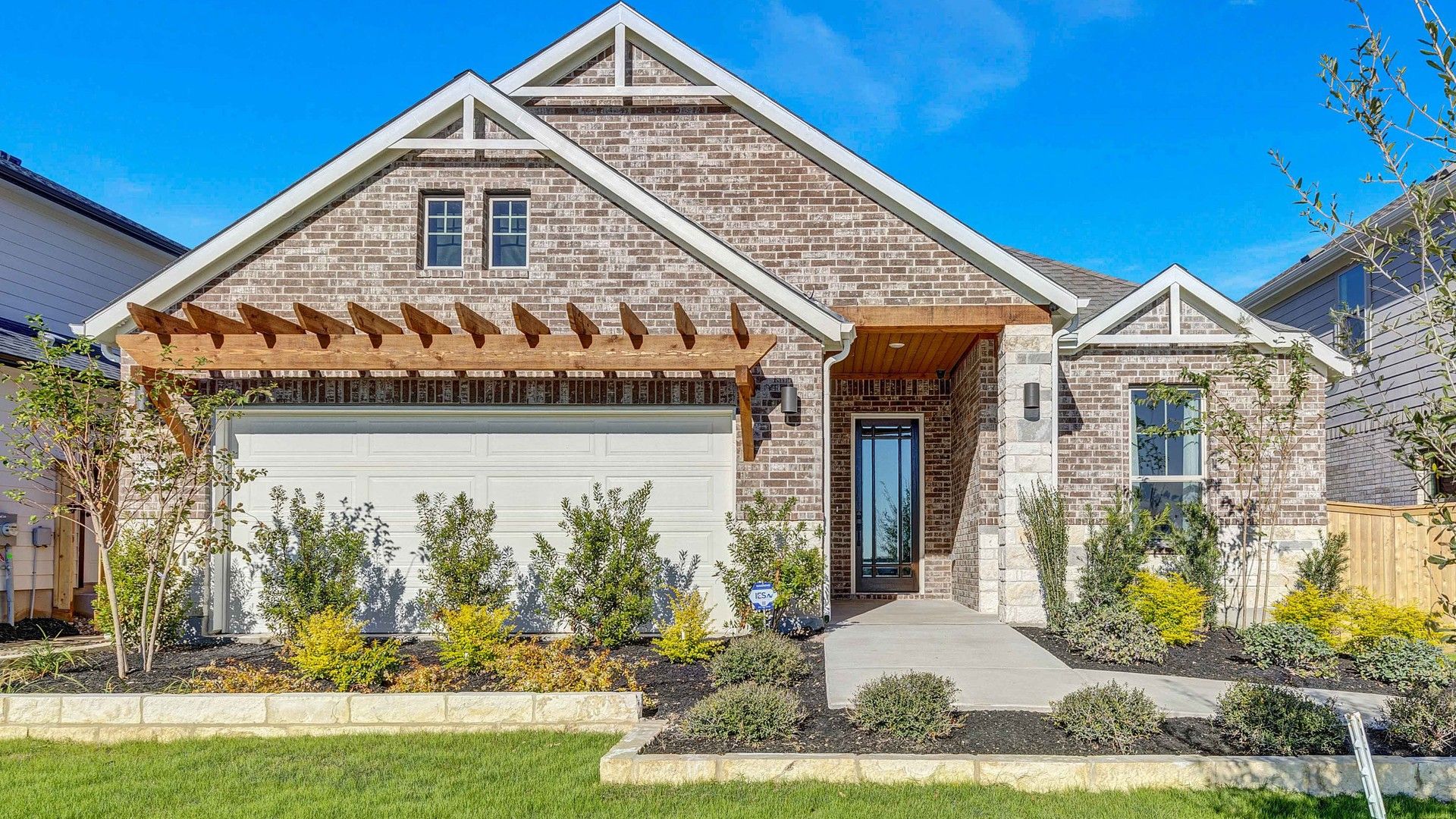 Exquisite brick exterior and elegant wood pergola enhance this Briarwood home.