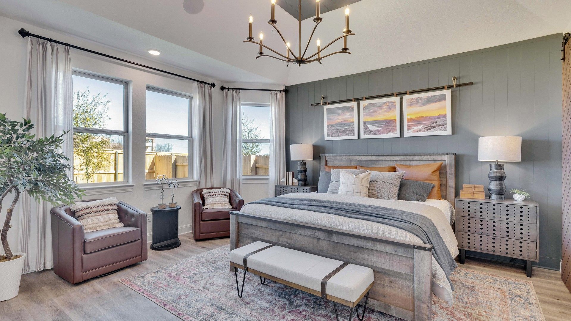 Briarwood bedroom showcases vaulted ceiling, refined chandelier, and plush design. A blend of luxury and comfort.