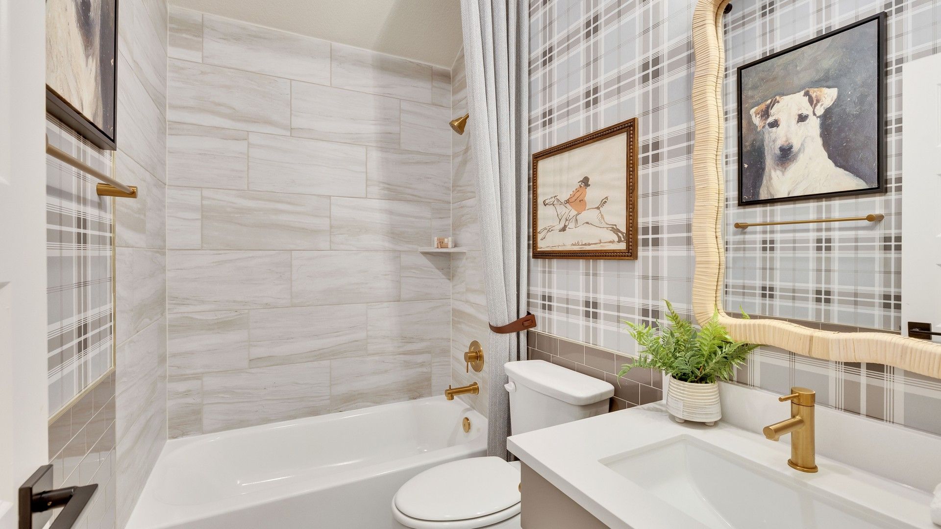 Immerse in luxury; bathroom features exquisite marble tiles and gold accents in Preserve at Lakeside Meadows.