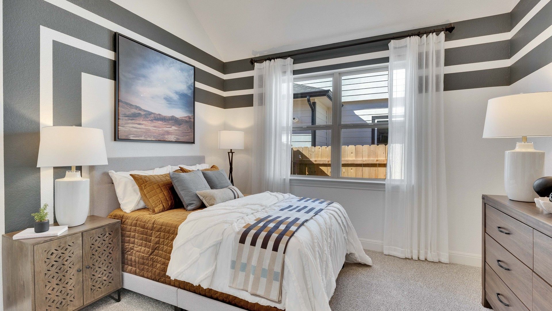 Briarwood bedroom boasts geometric wall art, plush textiles, and contemporary furniture for a sophisticated retreat.