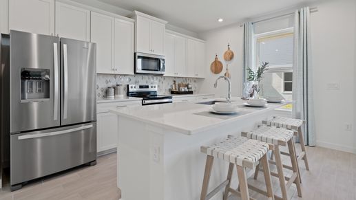 Trinity Place Staged Model Ambersweet Kitchen by DRB Homes in Saint Cloud FL