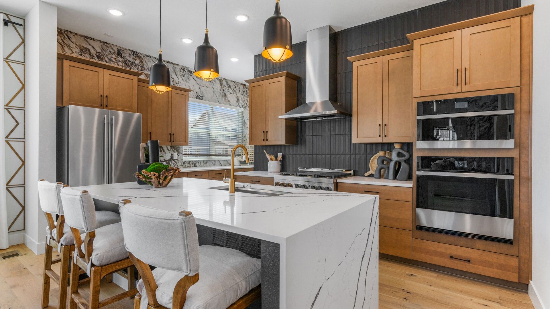 Experience opulence in Dillon Pointe with this exquisite marble island and custom wood cabinetry kitchen.