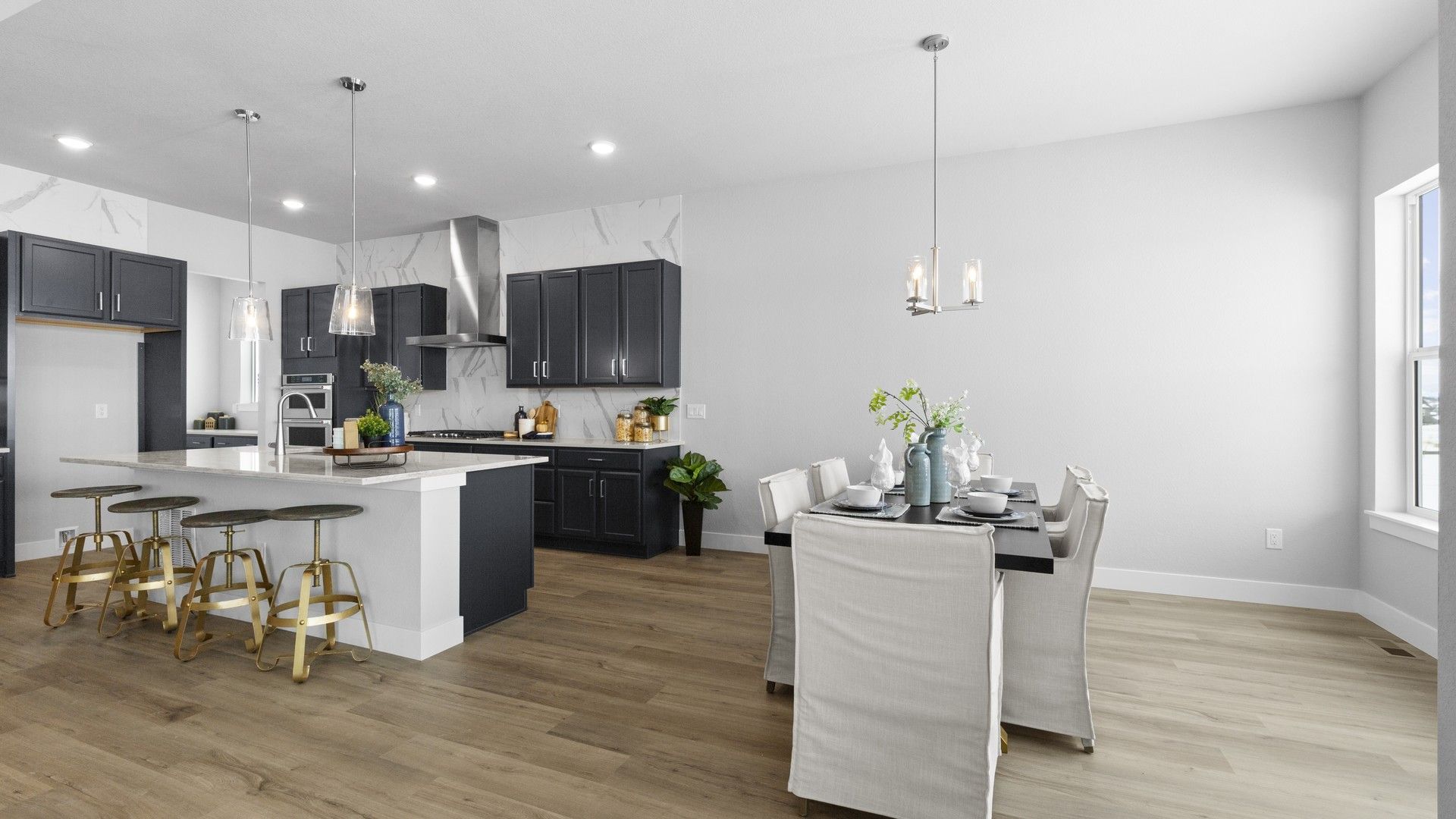 Luxurious Montaine kitchen boasts marble backsplash and crisp cabinetry, creating a serene culinary space.