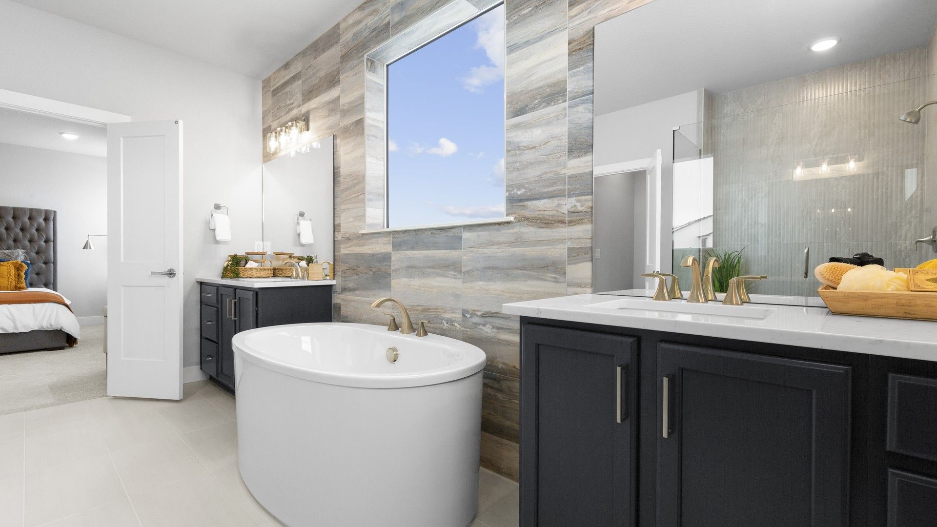 Experience elegance with a freestanding tub, marble accents, and refined fixtures in this Montaine home.