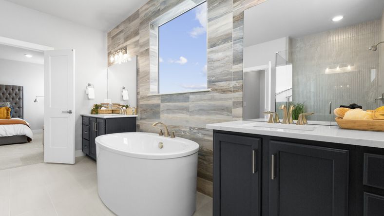 Experience elegance with a freestanding tub, marble accents, and refined fixtures in this Montaine home.