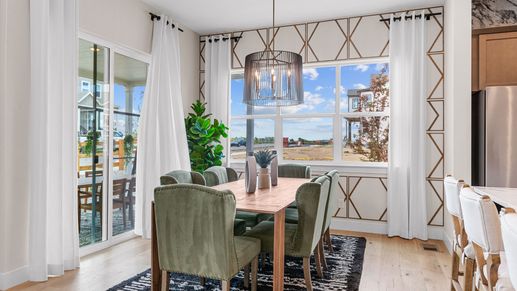 Experience luxury dining with chic geometric accents and lush green seating, nestled in Dillon Pointe's serene ambiance.