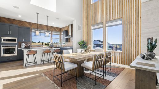 Elegant Dillon Pointe kitchen boasts vertical wood paneling and striking high ceilings.